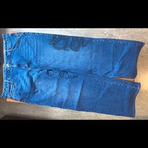 A pair of dark wash slouch fit jeans.